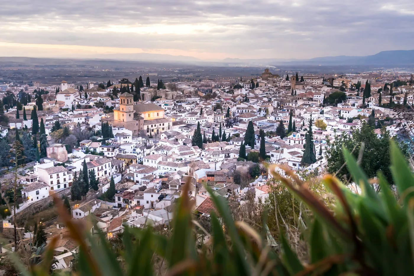 The whitewashed interior of a Sacromonte cave hung with copper pans