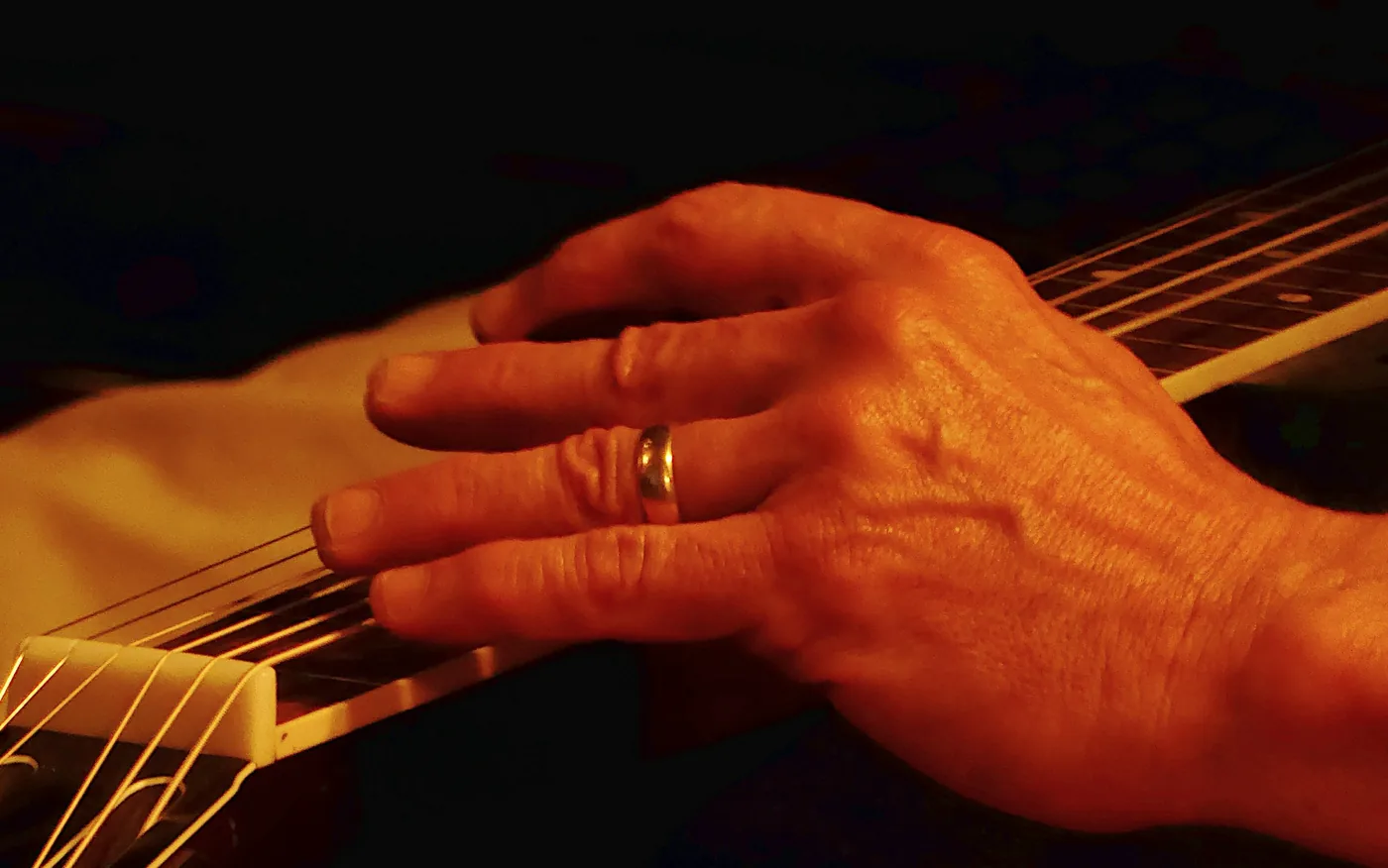 A flamenco guitarist playing inside a whitewashed cave